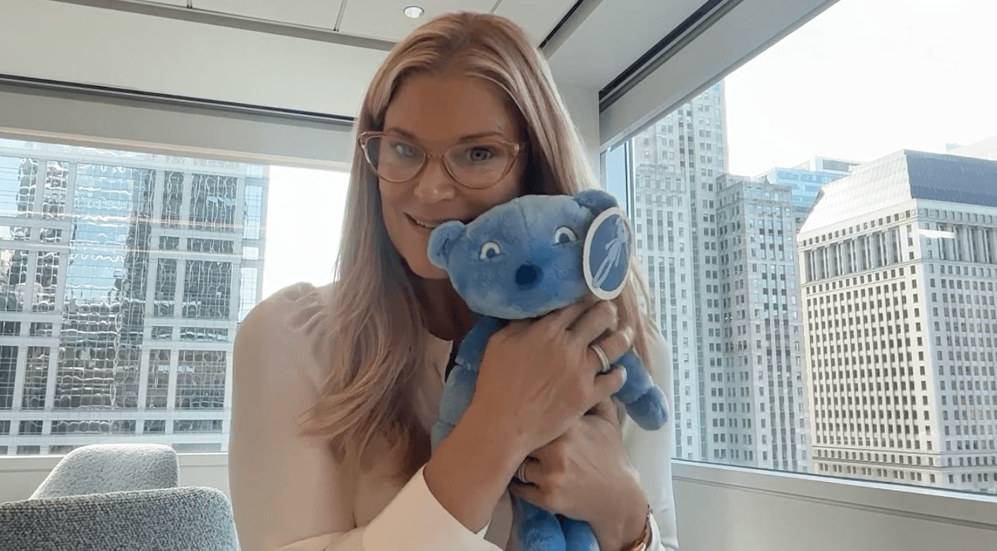 Liz shows off IGI, the therapeutic doll and play kit.